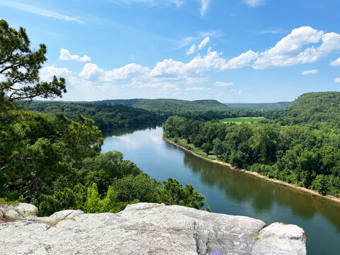 City Rock Bluff in Calico Rock Arkansas overlooking the White River in summer with a blue sky and clouds horizontal