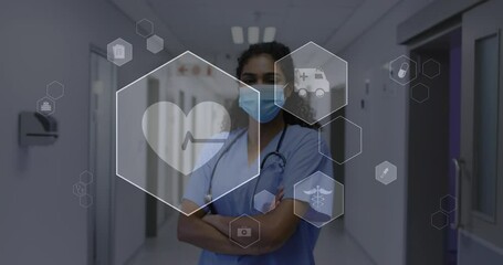 Animation of medical icons and data processing over biracial female doctor in face mask - Powered by Adobe