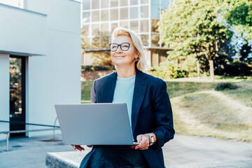 50's mature businesswoman looking ahead with confidence, middle aged company ceo director,...