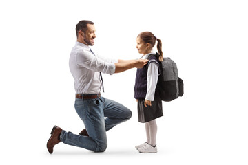 Full length profile shot of a father helping a girl getting ready for school - Powered by Adobe