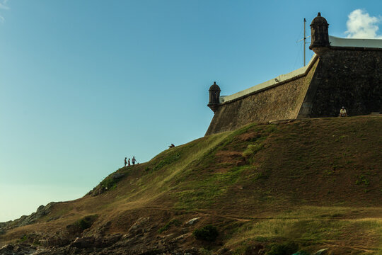 small people to scale with the "Farol da barra"  hill. People having fun, Afternoon at Salvador, bahia.
fortress sentries