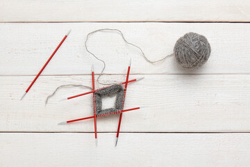 The process of knitting in the circle on double-sided knitting needles, ball of yarn.