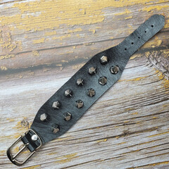 Black leather bracelet with spikes, holnitenes. An accessory for rockers, bikers, metalheads, goths...