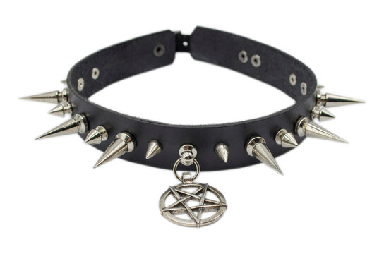Black leather bracelet with spikes, holnitenes and a pentagram. An accessory for rockers, bikers, metalheads, goths and punks. Steampunk style. Close-up subject photography.