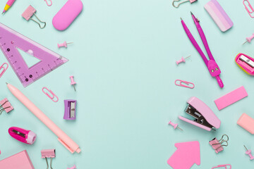 Pink school stationery on color backgroung, top view