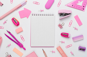 Pink school stationery on color backgroung, top view