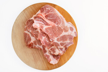 On white isolated background, there are large pieces of raw fresh meat marbling pork.