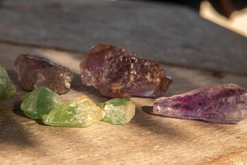 Semi precious gemstones in green and purple colors, mined in illegal mines in Mozambique, offered at street black market