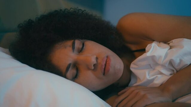 Young African American woman having problems with sleep at night, anxiety