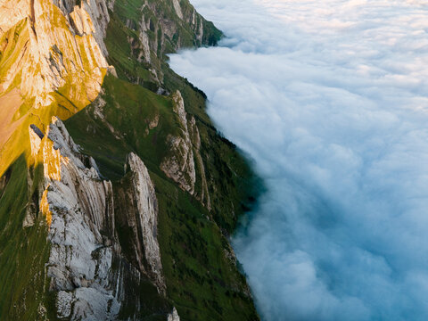 Clouds next to the Schaeffler mountain ridge swiss, Alpstein, Appenzell Switzerland, a ridge of the majestic Schaeffler peak in Switzerland. Drone Photography.