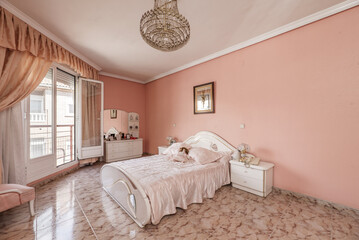 Bedroom with a double bed, white furniture and access