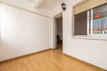 An empty enclosed terrace with double aluminum windows