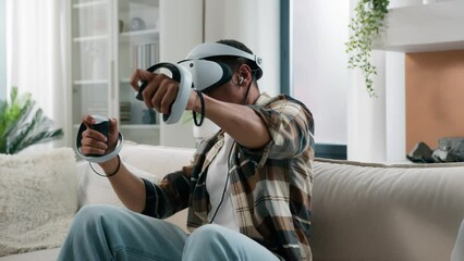 African American man in VR helmet glasses play video game virtual reality experience metaverse playing computer gaming addiction having fun at home guy enjoy 3d cyber world online with controllers