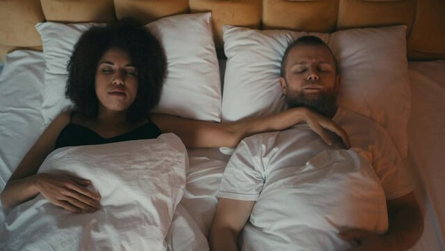 Young man cannot sleep because of wife's weird and funny sleeping positions