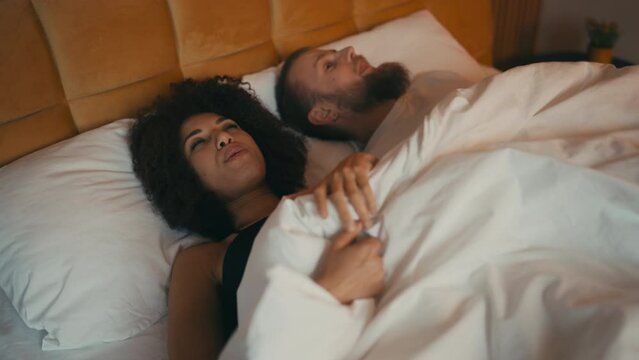 Interracial couple feeling happy after making love, happy marriage, romance