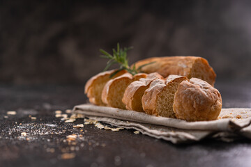Sliced baguette bread on wooden coaster and rustic background. Artisan Sourdough bread.
