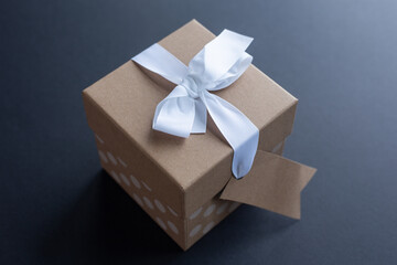 Brown paper gift box with white ribbon