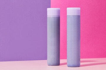 two shampoo bottles on colorful backgrounds