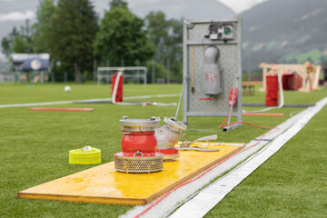 Equipment laid out on a green field for training of fire brigades
