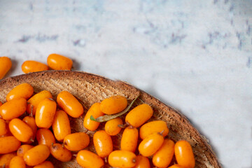 Collection of berries. A lot of useful sea buckthorn berries with green leaves, vitamin berry for...