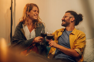 Caucasian happy couple looking at each others eyes with love while smiling.