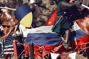 Medieval knights on horseback attack each other with spears. The war between Russia and Ukraine, as...