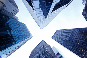 Obraz na płótnie Canvas New York City. Reflective skyscraper business office buildings. Bottom up view of big modern city urban landscape. Financial District