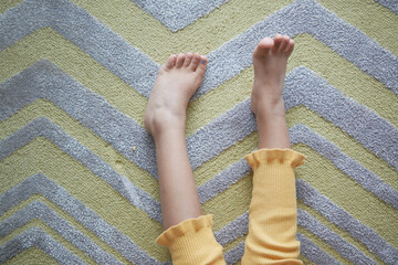 top view of dry child feet on soft carpet 
