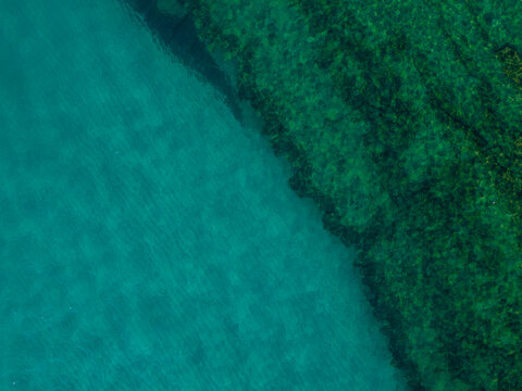 Italy, July 2023: aerial view from the drone of the caribbean sea with colors ranging from turquoise to light blue at the Baia di Riaci near Tropea in Calabria © cristian