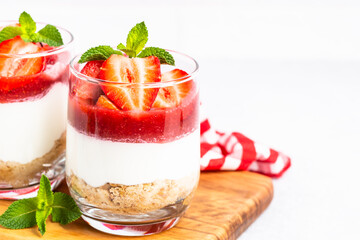 Strawberry cheesecake in glass, healthy dessert.