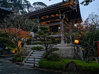 Buddhist shrine in Japan surrounded with manicured trees