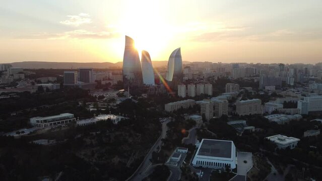 Baku, Azerbaijan - June 27, 2023: Aerial drone footage of the iconic Flame Towers during a breathtaking sunset, showcasing the impressive skyline of Baku