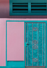 Asian Style Door with Metal Grate in Pink and Turquoise.