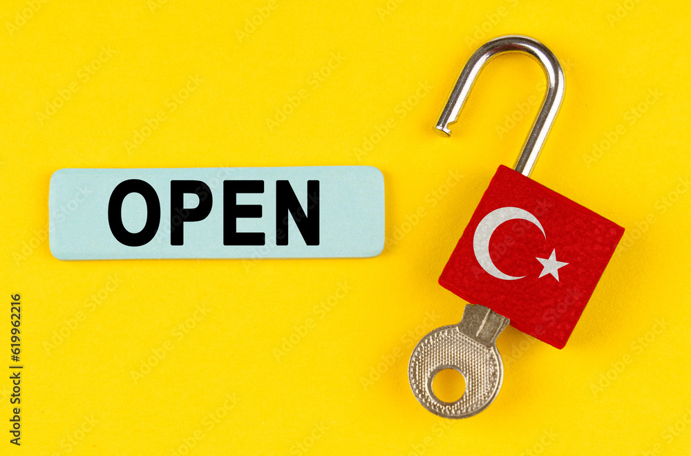 Aufkleber on the yellow surface is an open lock with a key and a sticker with the inscription - open