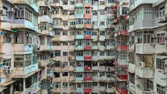 Yick Cheong and Yick Fat old apartment house exterior architecture in Hong Kong city, drone aerial view. Asian people residential life, transformer building or monster building travel landmark