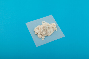 Pile of Guar gum powder or guaran. Food additive E412. Guar gum used in Bakery and Confectionery products. Fat Replacer, Dough Improver, Improve Moisture, Structure, Texture