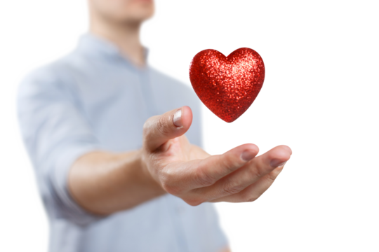 Red heart levitating over a male hand, cut out