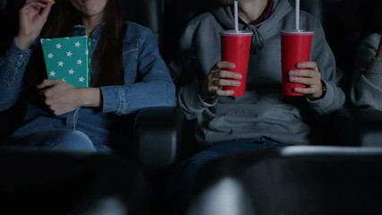 Friends came to the cinema for the premiere of the film. Unrecognizable people are sitting in comfortable chairs