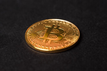 golden bitcoin closeup on black background