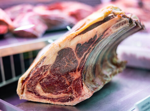 Frozen raw beef ribs laid out in butcher shop window