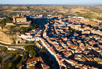 Aerial view of ancient fortified castle of Calatrava on background of Alcaniz cityscape in sunny autumn day, Spain..