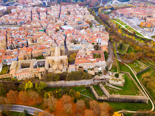 Aerial view of historic centre of Spanish city of Pamplona on bank of Arga river in autumn day
