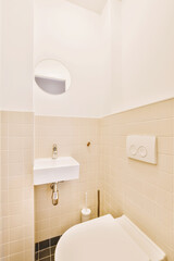 a bathroom with a sink and toilet paper dispensed on the wall next to it is a mirror