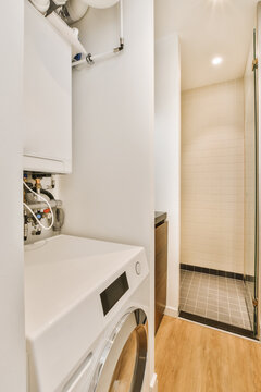 a laundry room with a washer and dryer next to the shower stall in the bathroom is very clean