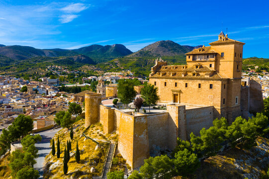 Aerial view of Caravaca de la Cruz cityscape with ancient fortified castle and Roman Catholic church, Spain