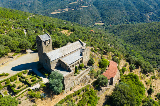 Scenic aerial view of ancient Romanesque building of Serrabone Priory in foothills of Canigou in summer, Pyrenees-Orientales, France..