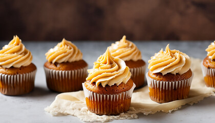 Homemade butterscotch cupcakes with caramel syrup and cream cheese frosting