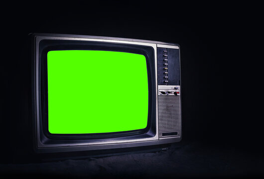 Naklejka Retro old TV It's still life with green screen in dark room