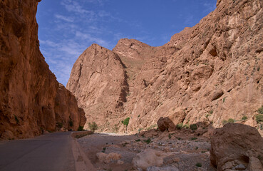 Todgha Gorge or Gorge du Todra, a limestone river canyon in High Atlas Mountains near the town Tinerhir, Morocco. High walls of the canyon. Asphalt road in the bottom of the gorge.
