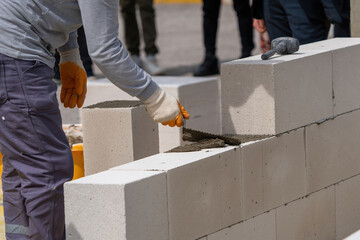 The bricklayer is working. Building a wall of aerated concrete. Gasbeton wall